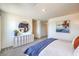 Bedroom featuring a stylish dresser with a round mirror, plush carpet, and natural lighting at 7915 Pandora Sky St # 403, North Las Vegas, NV 89084