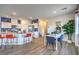 Bright dining area features modern table with seating for four, accented by a lush fiddle leaf fig plant at 7915 Pandora Sky St # 403, North Las Vegas, NV 89084