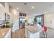 Modern kitchen featuring stainless steel appliances, white cabinets and a view into dining space at 7915 Pandora Sky St # 403, North Las Vegas, NV 89084