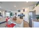 Open-concept kitchen with stainless steel appliances, granite counters and a seamless view to the living space at 7915 Pandora Sky St # 403, North Las Vegas, NV 89084