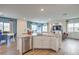 Open floor plan with kitchen island overlooking dining and living areas, perfect for entertaining and everyday living at 7915 Pandora Sky St # 403, North Las Vegas, NV 89084