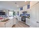 Modern kitchen features white cabinetry, stainless steel appliances, and a seamless transition to the living area at 7915 Pandora Sky St # 403, North Las Vegas, NV 89084