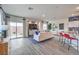 Bright, open-concept living room with patio access and modern furniture at 7915 Pandora Sky St # 403, North Las Vegas, NV 89084