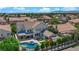 Aerial view of a home featuring a swimming pool, outdoor seating, play set, and lush greenery at 8000 Clock Tower Ct Ct, Las Vegas, NV 89117