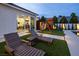 Relaxing backyard with lounge chairs, a playset, and an exercise room accessible through sliding glass doors at 8000 Clock Tower Ct Ct, Las Vegas, NV 89117