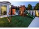 Backyard view of the playset and sauna next to the exercise room, perfect for Gathering fun and fitness at 8000 Clock Tower Ct Ct, Las Vegas, NV 89117