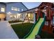 Home's backyard boasts a vibrant play area with artificial grass, a playset, and nearby access to a home gym at 8000 Clock Tower Ct Ct, Las Vegas, NV 89117