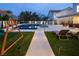 Well-manicured backyard with a pool, spa, play area, and lounge chairs, perfect for outdoor living and entertaining at 8000 Clock Tower Ct Ct, Las Vegas, NV 89117