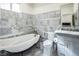 Bright bathroom with soaking tub, luxurious marble tile, and modern fixtures at 8000 Clock Tower Ct Ct, Las Vegas, NV 89117