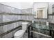 Chic bathroom with marble-look tile, decorative glass accents, and a unique glass vessel sink at 8000 Clock Tower Ct Ct, Las Vegas, NV 89117