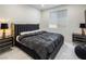 Luxurious primary bedroom showcasing a black bedframe with gold accents and window at 8000 Clock Tower Ct Ct, Las Vegas, NV 89117