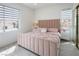 Charming bedroom featuring a soft pink bed, matching nightstands, and natural light from the windows at 8000 Clock Tower Ct Ct, Las Vegas, NV 89117