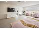 An expansive bedroom with a large TV, pink chairs and ensuite bathroom at 8000 Clock Tower Ct Ct, Las Vegas, NV 89117