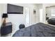 Modern bedroom boasts black nightstand, TV and an open door into another room at 8000 Clock Tower Ct Ct, Las Vegas, NV 89117
