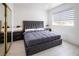 Contemporary bedroom with a dark upholstered bed frame, stylish nightstands, and modern window shades at 8000 Clock Tower Ct Ct, Las Vegas, NV 89117