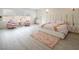 A light and airy bedroom with pale wood floors, large windows, and stylish pink decor at 8000 Clock Tower Ct Ct, Las Vegas, NV 89117