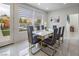 Dining room featuring an elegant dining table, modern lighting, and a view of the backyard at 8000 Clock Tower Ct Ct, Las Vegas, NV 89117
