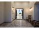 Inviting entryway and view into the living room of this home; rocking chairs for relaxing at 8000 Clock Tower Ct Ct, Las Vegas, NV 89117