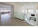 Bright foyer with glass railing overlooking the living area, showcasing the home's open floor plan at 8000 Clock Tower Ct Ct, Las Vegas, NV 89117