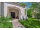 Inviting front entryway with a covered porch, double doors, and lush landscaping at 8000 Clock Tower Ct Ct, Las Vegas, NV 89117