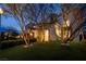 Beautiful two-story home with lush green lawn and mature trees in front yard at 8000 Clock Tower Ct Ct, Las Vegas, NV 89117
