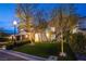 Beautiful two story home with manicured lawn and mature trees with landscape lighting at 8000 Clock Tower Ct Ct, Las Vegas, NV 89117