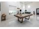 Spacious game room with a billiard table and a seating area, showcasing a modern and open design at 8000 Clock Tower Ct Ct, Las Vegas, NV 89117