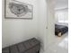 Hallway with light tile flooring includes gray ottoman with a view into bedroom at 8000 Clock Tower Ct Ct, Las Vegas, NV 89117
