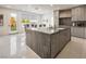 Modern kitchen with a large island, stainless steel appliances, and a view to the backyard at 8000 Clock Tower Ct Ct, Las Vegas, NV 89117