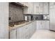 Stylish kitchen featuring a modern cooktop, updated appliances, and contemporary finishes at 8000 Clock Tower Ct Ct, Las Vegas, NV 89117