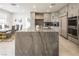 Open-concept kitchen with a large island, stainless steel appliances, and plenty of storage space at 8000 Clock Tower Ct Ct, Las Vegas, NV 89117