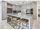 Kitchen island with stools offering seating and gray cabinets with high end stainless appliances at 8000 Clock Tower Ct Ct, Las Vegas, NV 89117