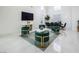 Bright living area with statement green and gold chairs, sleek marble coffee table, and modern decor at 8000 Clock Tower Ct Ct, Las Vegas, NV 89117