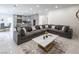 Open-concept living room with a large sectional sofa, kitchen, and dining area at 8000 Clock Tower Ct Ct, Las Vegas, NV 89117