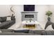 Comfortable living room with a sleek fireplace, modern decor, and a gray sectional sofa at 8000 Clock Tower Ct Ct, Las Vegas, NV 89117