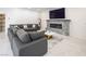 Relaxing living room with a gray sectional sofa, marble fireplace, and a mounted television at 8000 Clock Tower Ct Ct, Las Vegas, NV 89117