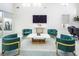 Bright living area with statement green and gold chairs, sleek marble coffee table, and modern decor at 8000 Clock Tower Ct Ct, Las Vegas, NV 89117