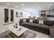 Bright and airy living room featuring a large sectional sofa and access to dining and kitchen areas at 8000 Clock Tower Ct Ct, Las Vegas, NV 89117