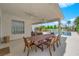 Spacious covered patio featuring a dining area, ceiling fans, and a view of the backyard pool at 8000 Clock Tower Ct Ct, Las Vegas, NV 89117