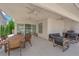 Covered patio with ceiling fans, a dining table, and comfortable outdoor seating with a grill at 8000 Clock Tower Ct Ct, Las Vegas, NV 89117