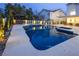 Inviting backyard pool and spa features a swim-up bar, accent lights, and a covered outdoor dining area at 8000 Clock Tower Ct Ct, Las Vegas, NV 89117