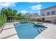 Beautiful backyard pool and spa featuring lush landscaping, lounge area and covered patio at 8000 Clock Tower Ct Ct, Las Vegas, NV 89117