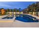 Inviting backyard features a sparkling pool and spa, play set, and relaxing shaded swing set at 8000 Clock Tower Ct Ct, Las Vegas, NV 89117