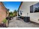 A small backyard featuring a table, plants and the home's HVAC system at 8811 Pauley Hills St, Las Vegas, NV 89131
