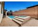 This backyard features a pool and attached hot tub, plus an outdoor storage shed and brick wall at 8811 Pauley Hills St, Las Vegas, NV 89131
