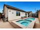 This backyard features a pool and attached hot tub and an outdoor storage shed at 8811 Pauley Hills St, Las Vegas, NV 89131