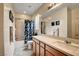 Well-lit bathroom with a shower-tub combo and a spacious countertop with a sink at 8811 Pauley Hills St, Las Vegas, NV 89131