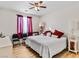 Comfortable bedroom with stylish decor, wood flooring and bright natural light at 8811 Pauley Hills St, Las Vegas, NV 89131