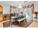Dining room featuring an elegant table, decorative rug, and chandelier lighting at 8811 Pauley Hills St, Las Vegas, NV 89131