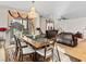Open dining area with a chandelier, decorative curtains, and views to the living room at 8811 Pauley Hills St, Las Vegas, NV 89131